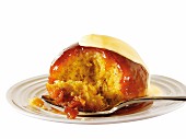Sponge pudding with strawberry sauce and custard