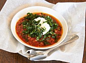 Pork ragout with wheat grains, spinach and a poached egg