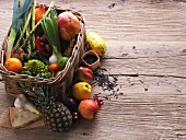 A basket of fresh fruit and vegetables with cheese and rice