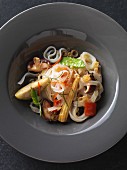 Vegan rice noodles with fried, oriental vegetables