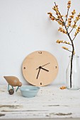 Wall clock with leather face, wooden bird and bowl