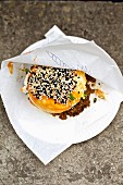 Gua Bao burger with sesame seeds on a disposable plate (oriental street food)