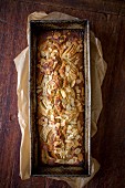 Apple cake with flaked almonds in a loaf tin