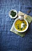 Cream of vegetable soup with sour cream, parsley and black pepper