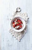 Mediterranean-style tomato salad with capers, onions and pine nuts
