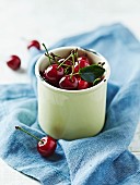Sour cherries in an enamel mug
