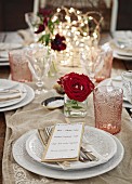 A festively laid table with rose decorations