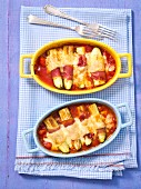 Gratinated courgette with ham and cheese in tomato sauce