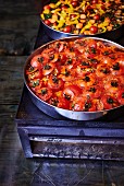 Stuffed tomatoes in a baking tin