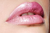A woman's lips with pink lipstick, close-up