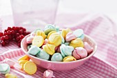 Colourful meringue dots in a pink bowl