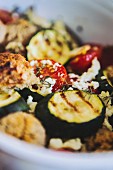 Grilled vegetables with goat's cheese and bread (close-up)