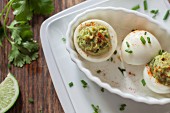 Two devilled eggs with avocado cream