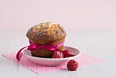 A white chocolate muffin with raspberries