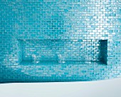 Drinking glasses in niche tiled in blue mosaic tiles