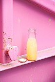 A bottle of homemade peach lemonade with basil
