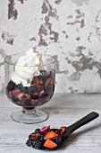 Fruit salad with blackberries, plums, grapes and cream