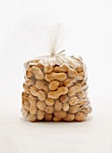 A plastic bag of peanuts against a white background