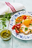 Fried egg and sweet potato fritter with tomatoes