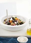 Oven baked vegetable salad with rice pasta and feta cheese