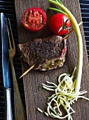 Stuffed beef steak with tomatoes and spring onions