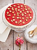 Cheesecake with strawberry glaze and hazelnuts