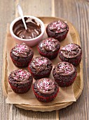 Chocolate cupcakes with chocolate sauce and sugar sprinkles