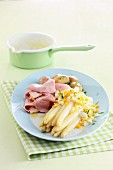 White asparagus with an egg sauce, ham and potatoes