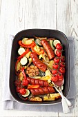 Sausage with potatoes, courgettes, cherry tomatoes and onions