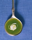 Potato soup with watercress in a ladle