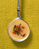 Potato soup with sage and bacon in a ladle