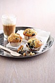 Blueberry muffins with latte macchiato on a tray