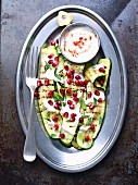 Grilled courgettes with a spicy yoghurt sauce and pomegranate seeds