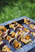 Grilled chicken skewers with pineapples and onions