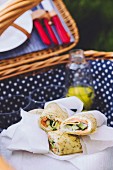 Salmon and cucumber wraps in a picnic basket