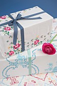 Gifts wrapped in old, vintage-style table cloths decorated with cross-stitch embroidery