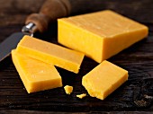 Double Gloucester cheese with a knife