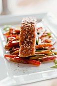 Oven-roasted salmon with a sesame seed crust on roasted vegetables
