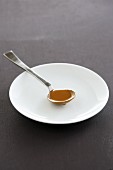 A spoonful of gravy on a plate