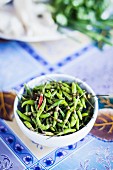 A bowl of green chilli peppers
