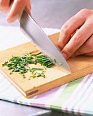 Cutting the chives on the chopping board