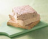 A stack of three different slices of tofu