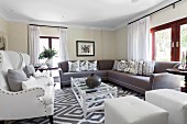 Large, elegant sofa combination in classic living room with pale and grey upholstered furnishings