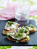 Crostini topped with fish and green asparagus