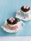 Easter cupcakes decorated with a cream topping and Easter nests