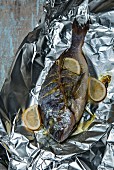 Seabream roasted in aluminium foil with lemons and rosemary