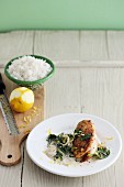 Fried chicken breast fillet with lemon zest and spinach