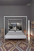 Bedroom with modern four-poster bed on antique terrazzo floor