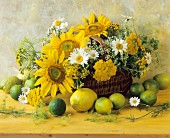 An arrangement of citrus fruits and yellow summer flowers in a wicker basket