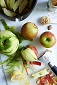 Peeled apples and ingredients for apple pie